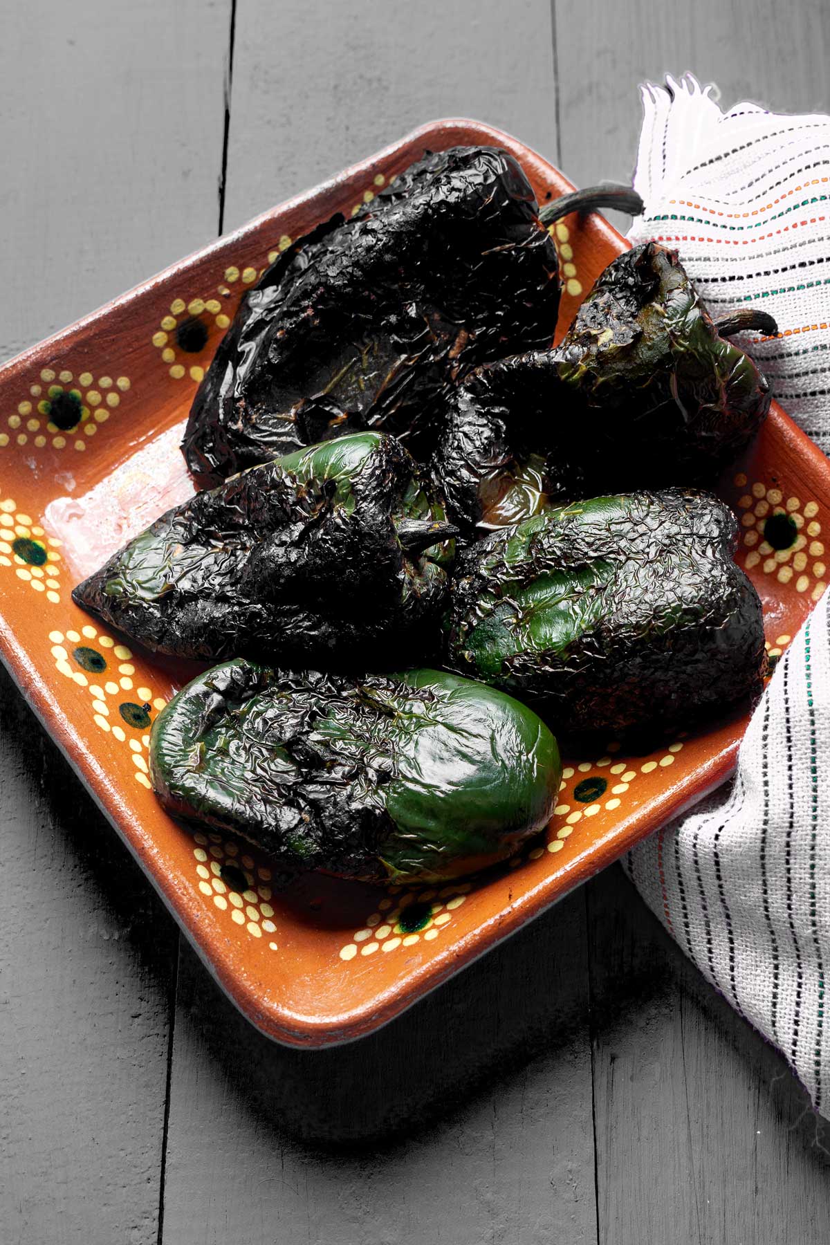Charred poblano peppers on a plate